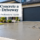 Fresh concrete garage driveway in front of a modern house, with a worker smoothing the surface and the text “How to Concrete a Garage Driveway – Step-by-Step Professional Guide